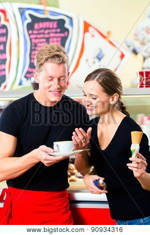 Ice-cream seller and waiter working in cafe selling ice cream wafer and coffee