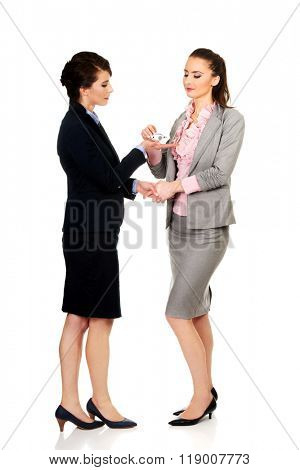 Businesswoman giving a plane to her partner.