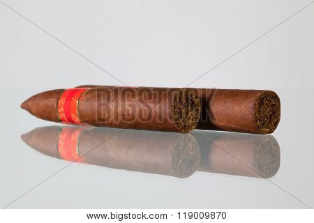 Different Cigars On A  Glass Desk
