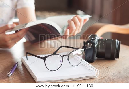 Woman Reading Book In Coffee Shop