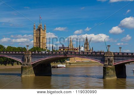 LONDON UK - 18TH JULY 2015: Lambeth Bridge in London during the summer. The River Thames Westminster and a Big Bus Tour Bus can be seen.