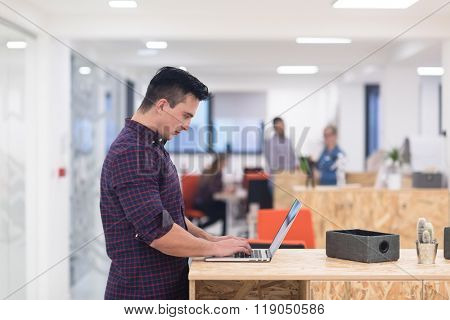 portrait of young businessman in casual clothes at modern  startup business office space,  working on laptop  computer
