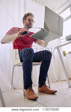 Man sitting at a glass desk shot from beneath