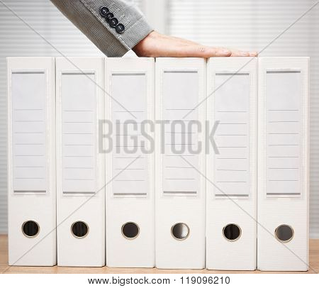 businessman holding organized documentation in binders accounting services and bookkeeping concept