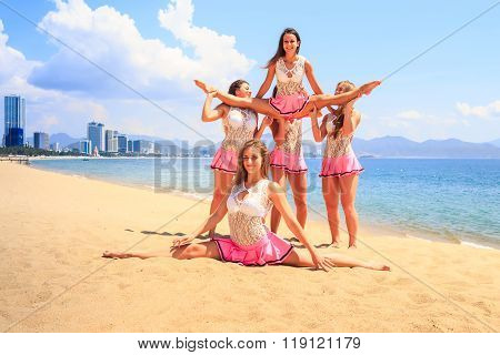 Cheerleaders Perform Straddle Stunt With One Split On Beach