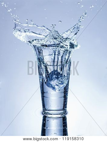 Icecube Splashing Into A Glass Of Water