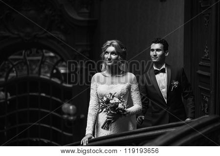 Beautiful Bride & Goom Posing On Luxury Wooden Stairs In Theatre B&w