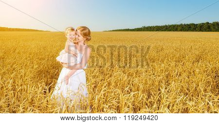 Happy Family In Summer Nature. Mother And Baby Daughter In The Wheat Field