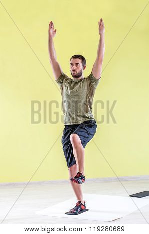 Man at gym, exercising with friction pads