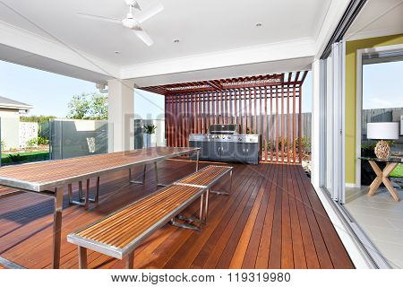 Long Wooden Table And Benches With Modern Grill Cabinet  In A Luxurious Hotel