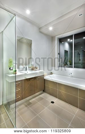 Modern Bathroom With Dark Color Floor Tiles With Lights On