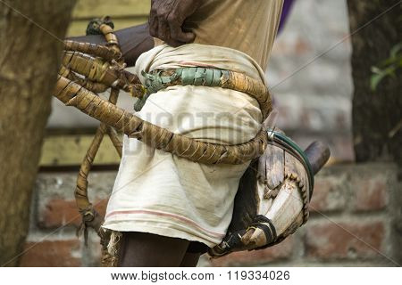 Editorial documentary. Old climber on coconut tree