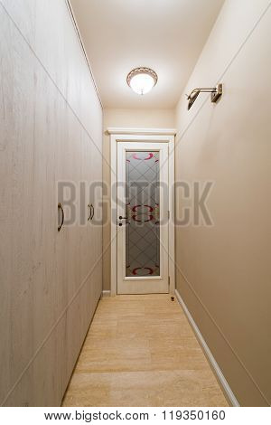 Wooden door at the end of coridor
