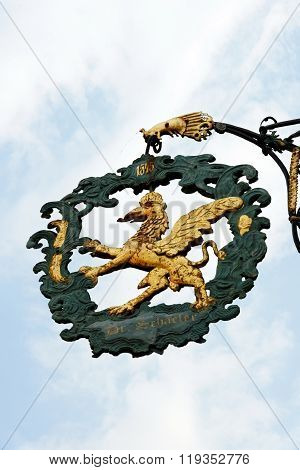 DINKELSBUHL GERMANY - AUGUST 10 2015: A wrought iron hanging sign in Dinkelsbuhl one of the best-preserved medieval towns in Europe part of the famous Romantic Road tourist route
