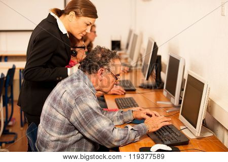 Group Of Adults Learning Computer Skills. Intergenerational Transfer Of Knowledge.