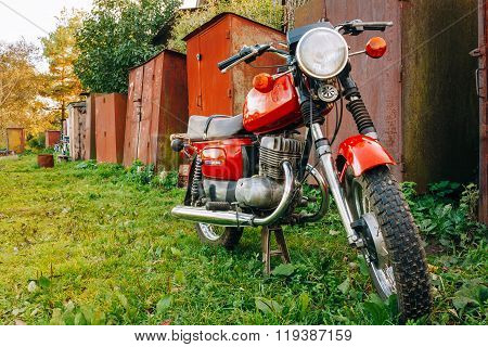 Old Red Russian Soviet Motorcycle Voshod Parked On Green Grass i