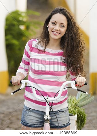 Happy beautiful girl riding her bicycle 