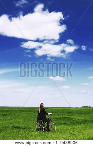 Happy Young Woman With A Vintage Bicycle On A Green Meadow. Youn