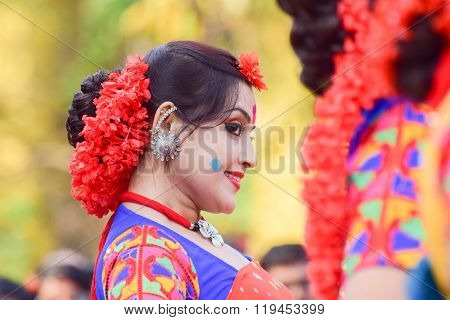 KOLKATA INDIA - MARCH 5 2015 : Young girl dancer's joyful expression at Holi / Spring festival known as Dol (in Bengali) or Holi (in Hindi) celebrating arrival of Spring in India. A very popular festival amongst Bengalis.