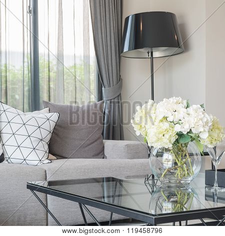 Glass Vase Of Flower On Glss Table In Moder Living Room
