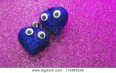 Two Big Hearts In Love With Open Eyes In The Purple Background