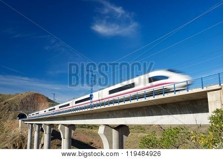 view of a high-speed train crossing a viaduct in Purroy, Zaragoza, Aragon, Spain. 