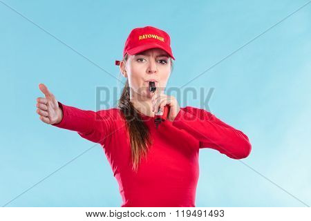 Lifeguard Woman In Cap On Duty Blowing Whistle.