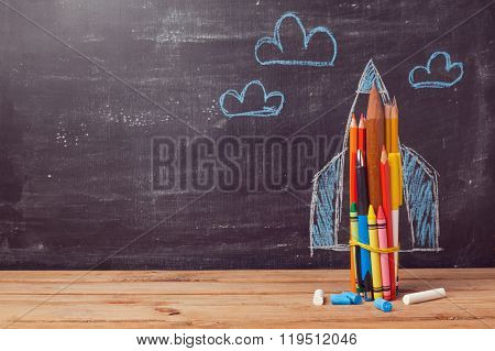 Back to school background with rocket made from pencils
