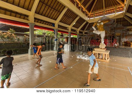 BALI, INDONESIA - FEB 25, 2016: Unidentified local child during built Ogoh-ogoh are statues for the Ngrupuk parade, which takes place on the eve of Nyepi day. Nyepi is a public holiday in Indonesia.
