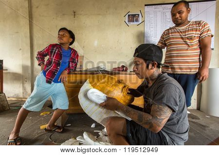 BALI, INDONESIA - FEB 25, 2016: Unidentified local people during built Ogoh-ogoh are statues for the Ngrupuk parade, which takes place on the eve of Nyepi day. Nyepi is a public holiday in Indonesia.