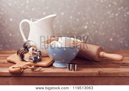 Rustic kitchen background with eggs and heart cookie cutters.