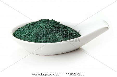 Spirulina Powder In White Porcelain Spoon On White Background