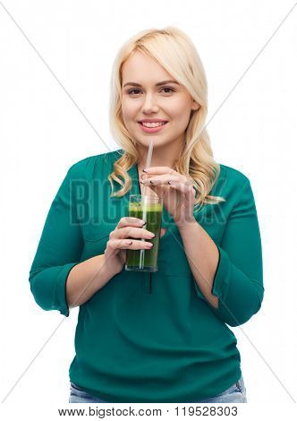healthy eating, vegetarian food, diet, detox and people concept - smiling young woman drinking green vegetable juice or smoothie from glass