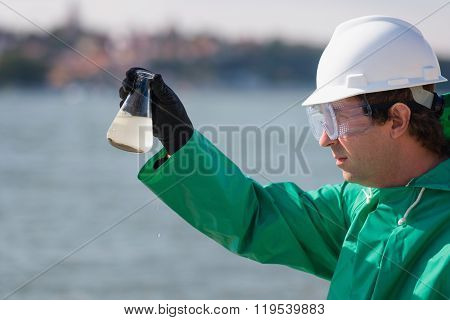 Sample Of Polluted Water In Environmentalist's Hand