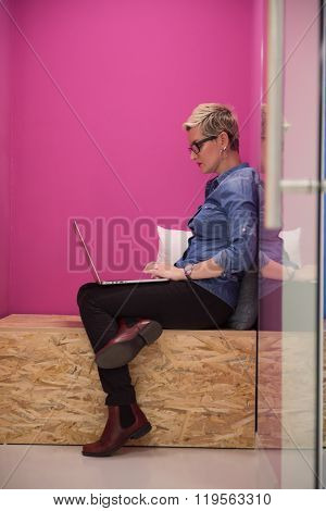 young woman in crative box working on laptop computer, startup business modern office room  interior