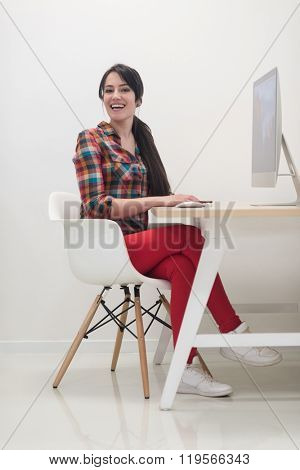 startup business, woman  working on dektop  computer at creative modern office relaxing and have fun