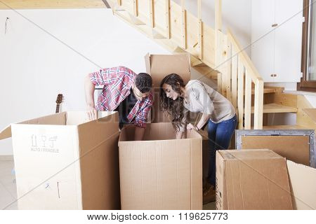 Young Couple Opened The Boxes For The New House