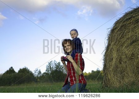 Young Woman With Baby Girl On Shoulders