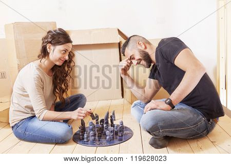 Young Couple Playing Chess After The Move