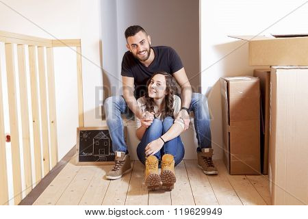 young happy couple moves into new home