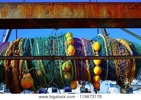 Trawler boat net rolled in its axis from Mediterranean port