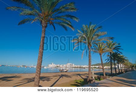 Mid morning sun on Ibiza waterfront.  Warm sunny day along the beach in St Antoni de Portmany Balear