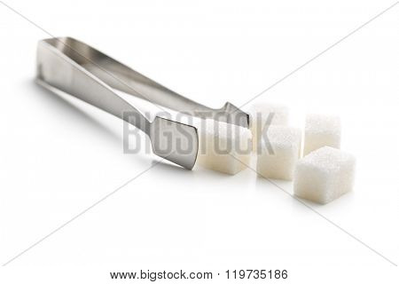 sugar cubes and sugar tongs on white background