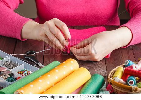 Closeup Of Woman Hands Sewing Pink Hamdmade Toy