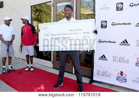 Ricky Smith and a check from the Will and Jada Smith Foundation at the inaugural Stephen Bishop celebrity golf invitational benefiting R.A.K.E.,  Feb. 15, 2016 , Calabasas Country Club, Calabasas, CA.