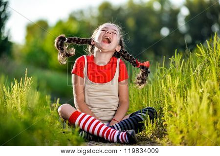 naughty girl with pigtails opens his mouth and shouts the summer on the nature