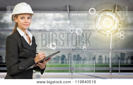 Smiling businesslady in helmet