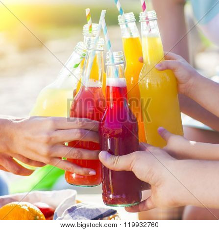 Group Of Friends Holding Drinks At The Summer Picnic