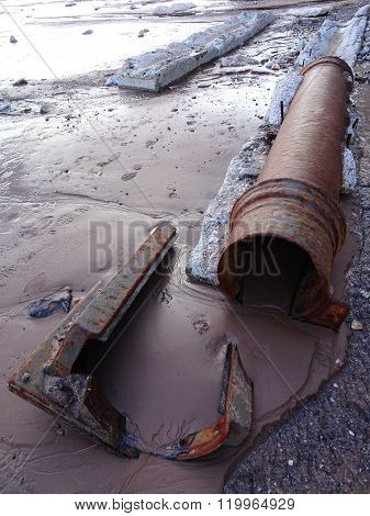 Rusty Outlet Pipe Upon Beach Seascape