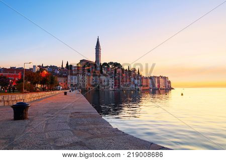 Sunset at medieval town of Rovinj colorful with houses and church in Croatia